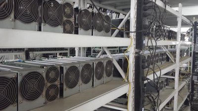 A modern cryptocurrency mining farm showcasing rows of mining machines.