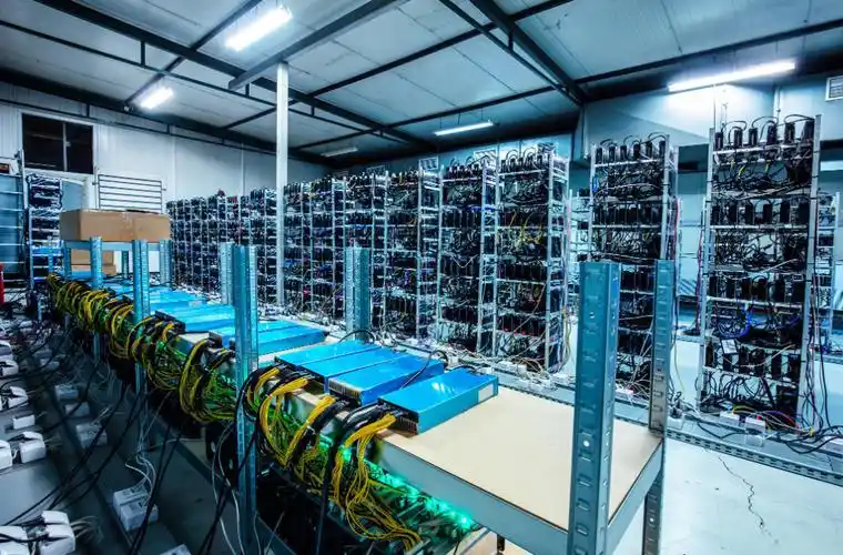 Miners installing mining rigs in a large mining farm.